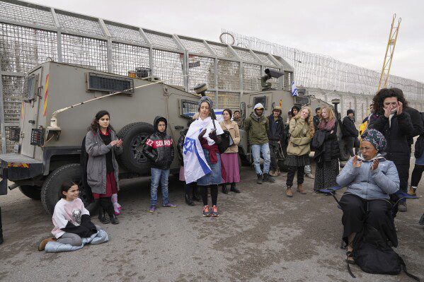 Demonstrators block the path of humanitarian aid heading to the Gaza Strip at the Nitzana border crossing with Egypt in southern Israel, Friday, February 2, 2024. (AP Photo/Tsafrir Abayov)