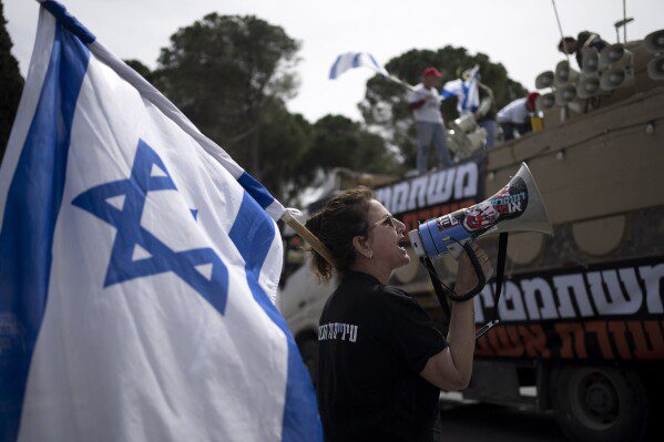 Members of Brothers and Sisters in Arms and Bonot Alternativa (Women Building an Alternative) protest Israel's exemptions for ultra-Orthodox Jews from mandatory military service, near the Prime Minister's Office in Jerusalem, Tuesday, March 26, 2024. (AP Photo/Maya Alleruzzo ) )