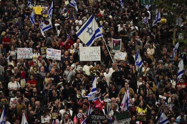 People protest against the government of Israeli Prime Minister Benjamin Netanyahu and call for the release of hostages held by Hamas in the Gaza Strip in Tel Aviv, Israel, Saturday, April 27, 2024. (AP Photo/Ohad Zwigenberg)