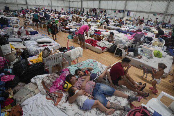 Residents rest at a temporary shelter for people whose homes were flooded by heavy rains, in Canoas, Rio Grande do Sul state, Brazil, Wednesday, May 8, 2024. (AP Photo/Carlos Macedo)