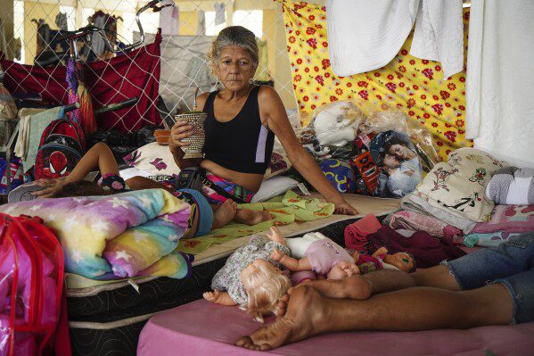 Residents rest at a temporary shelter for people whose homes were flooded by heavy rains, in Canoas, Rio Grande do Sul state, Brazil, Wednesday, May 8, 2024. (AP Photo/Carlos Macedo)