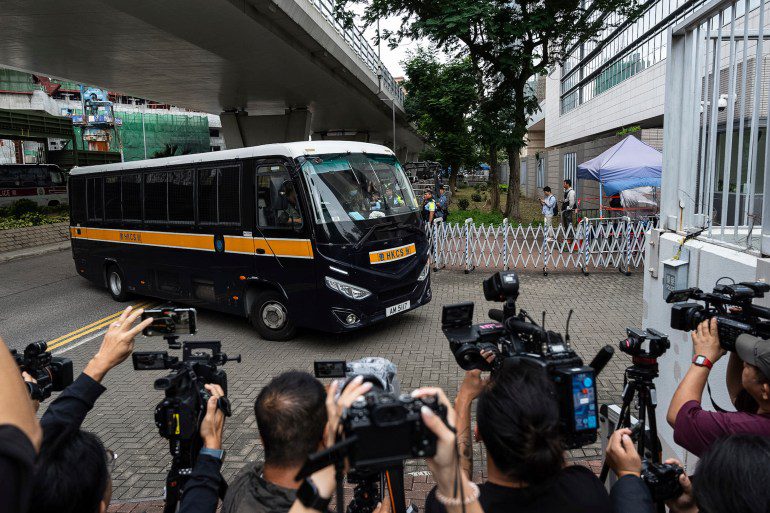 The prison minibus carrying some of the defendants who were refused bail arrived at the court for the hearing.