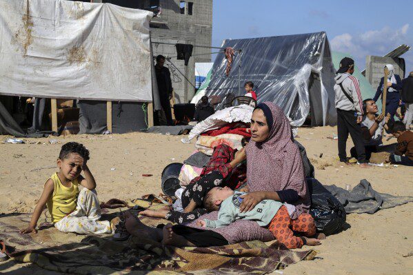 FILE - Palestinians displaced by Israel's bombing of the Gaza Strip set up camp in Rafah on December 6, 2023. The tent camps stretch more than 16 kilometers (10 miles) along the Gaza coast, filling the beach and spilling over into empty lots, fields and city streets.  (AP Photo/Hatem Ali, File)