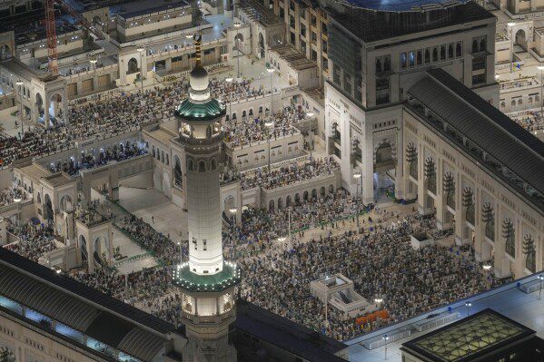 Muslim pilgrims perform prayers at the Grand Mosque, during the annual Hajj in Mecca, Saudi Arabia, Tuesday, June 11, 2024. (AP Photo/Rafiq Maqbool)