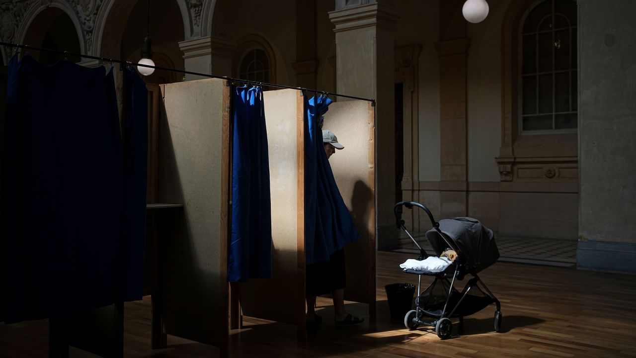 A voter leaves his booth at a polling station in Lyon, France, Sunday, July 7.