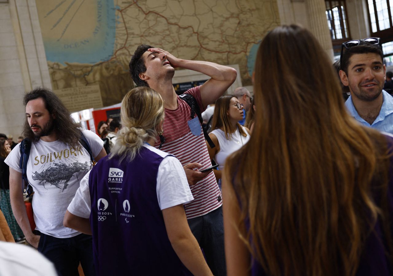 Passengers react inside Bordeaux Saint-Jean station after threats against France's high-speed rail network, Friday, July 26 in Bordeaux, France.