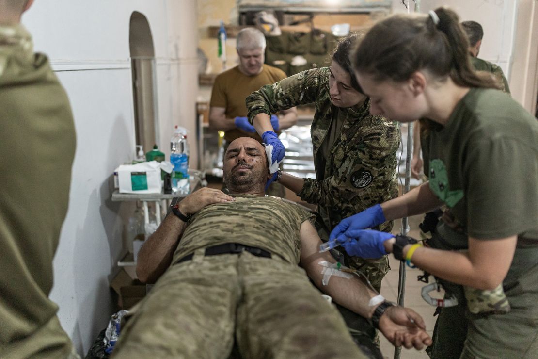 Ukrainian military medical personnel treat wounded soldiers at a stabilization point in the Pokrovsk direction.