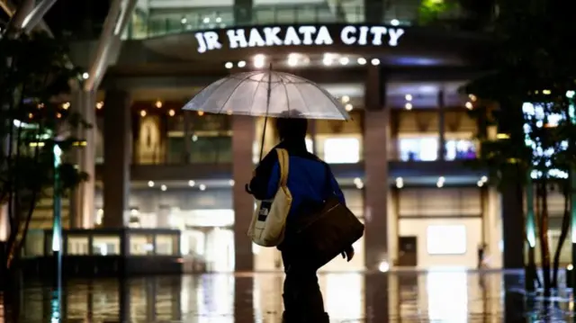 A woman holds an umbrella in Fukuoka on the southern island of Kyushu on Thursday.