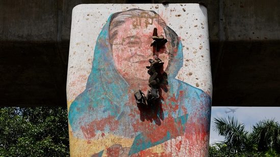 A mural of Bangladeshi Prime Minister Sheikh Hasina is seen being vandalized by protesters, a day after her resignation, in Dhaka. (Reuters File Photo)